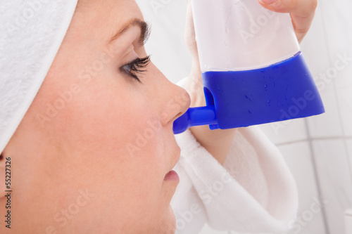 Photo: Young Woman Cleaning Nose Young Woman Cleaning Nose