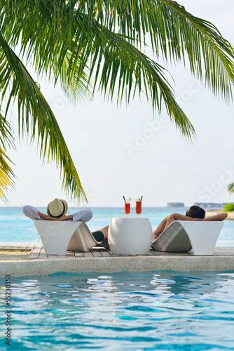 Photo: happy young couple relax and take fresh drink happy young couple relax and take fresh drink