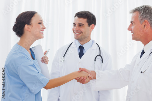 Photo: Surgeon thanking the doctor for helping her Surgeon thanking the doctor for helping her