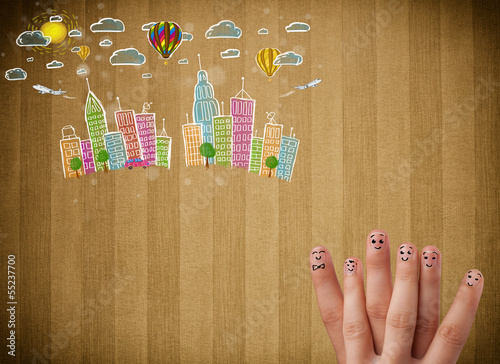 Photo: Happy smiley fingers looking at colorful handrawn cityscape Happy smiley fingers looking at colorful handrawn cityscape