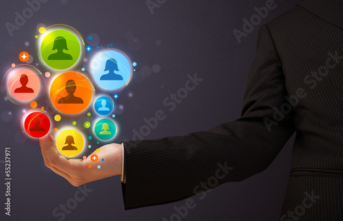 Photo: Social network icons in the hand of a businessman Social network icons in the hand of a businessman