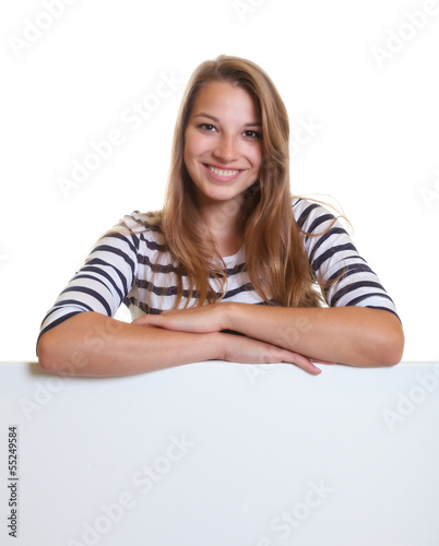 Photo: Laughing young woman leans on a signboard Laughing young woman leans on a signboard