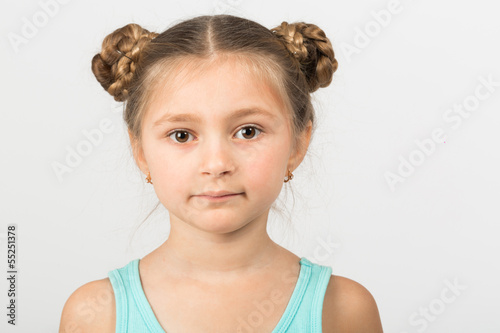 Photo: Close portrait of a girl with an interesting hairdo Close portrait of a girl with an interesting hairdo