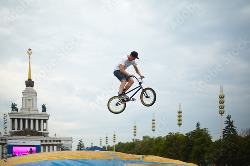 Photo: Young man jumps on bike Young man jumps on bike