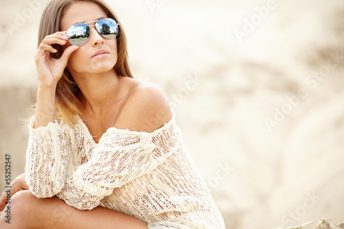 Photo: Beautiful sexy model relaxing on the beach Beautiful sexy model relaxing on the beach