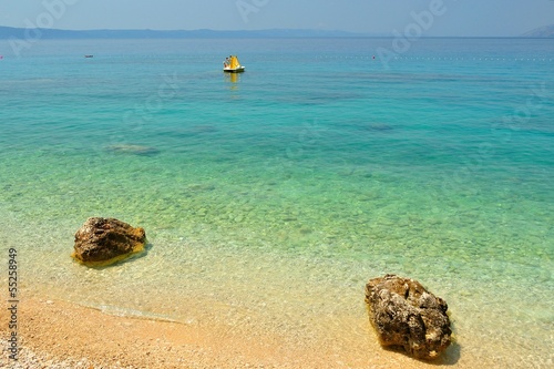 Photo: Amazing beach with two big stones near Tucepi, Croatia Amazing beach with two big stones near Tucepi, Croatia