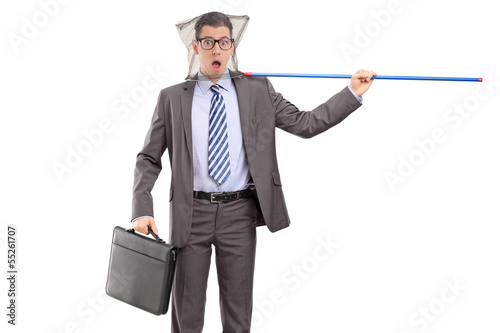 Photo: Young professional man in suit caught in a fishing net Young professional man in suit caught in a fishing net