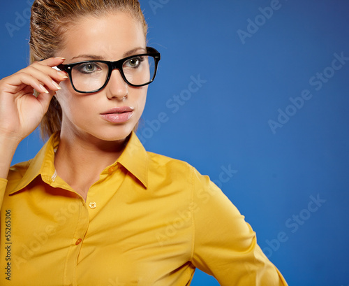 Photo: Young businesswoman on blue background Young businesswoman on blue background