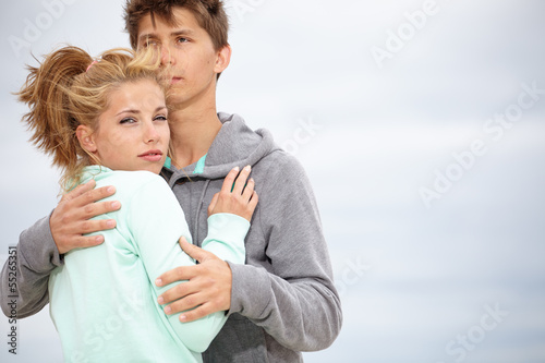 Photo: Romantic young couple on autumn beach Romantic young couple on autumn beach