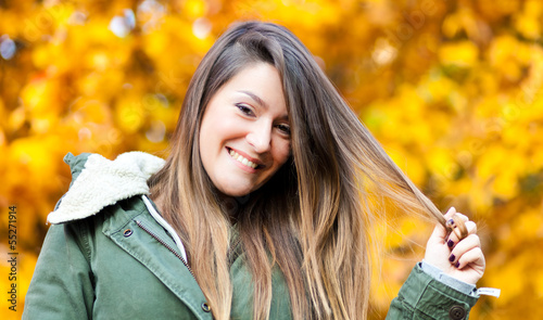 Photo: Woman at the park during autumn Woman at the park during autumn