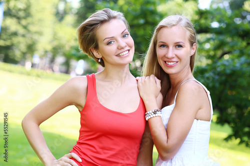 Photo: Two girls are having fun in the park Two girls are having fun in the park