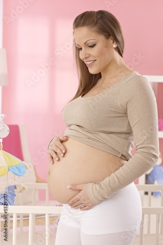 Photo: Happy pregnant woman with naked belly Happy pregnant woman with naked belly