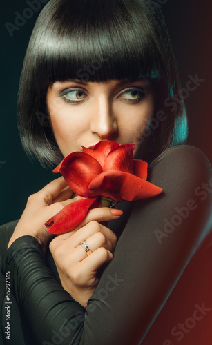 Photo: Female with rose looking away Female with rose looking away