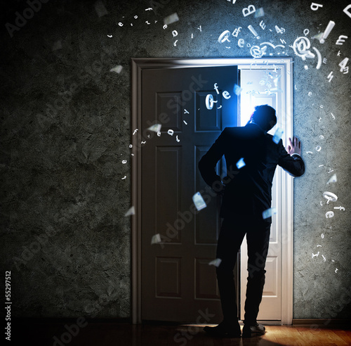 Photo: Young businessman opening door Young businessman opening door