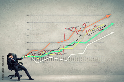 Photo: Businessman pulling graph Businessman pulling graph