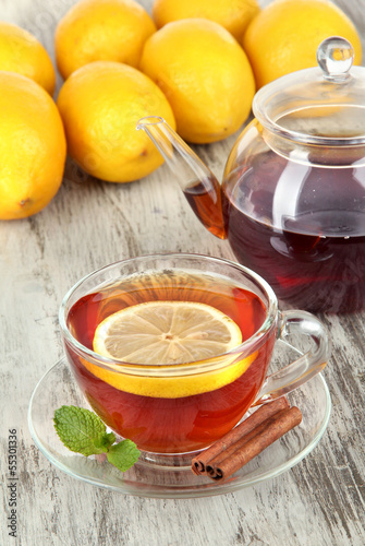 Photo: Cup of tea with lemon on table close-up Cup of tea with lemon on table close-up