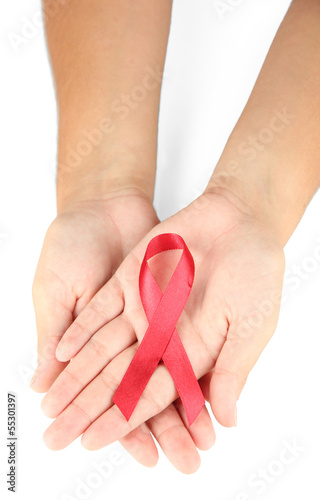Photo: AIDS ribbon in hands isolated on white AIDS ribbon in hands isolated on white