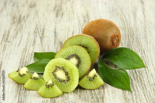 Photo: Ripe kiwi on wooden table close-up Ripe kiwi on wooden table close-up