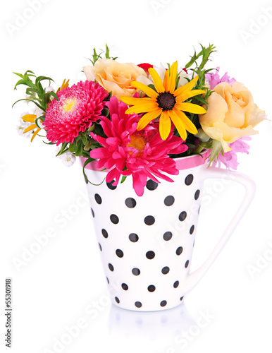 Photo: Beautiful bouquet of bright flowers in color mug, isolated Beautiful bouquet of bright flowers in color mug, isolated