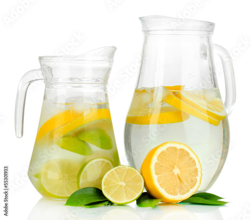 Photo: Cold water with lime, lemon and ice in pitchers isolated Cold water with lime, lemon and ice in pitchers isolated