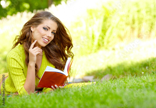 Photo: beautiful girl with book in the autumn park beautiful girl with book in the autumn park