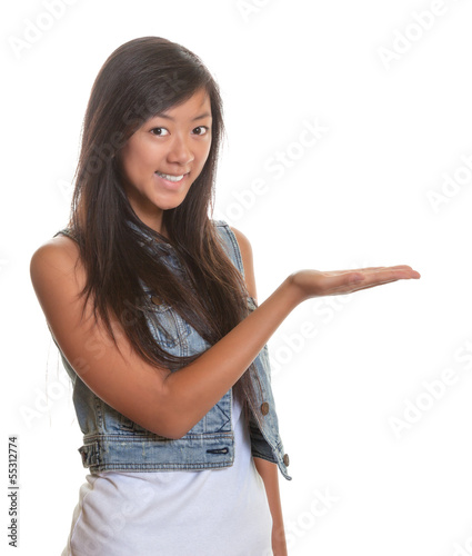 Photo: Presenting asian woman on a white background Presenting asian woman on a white background