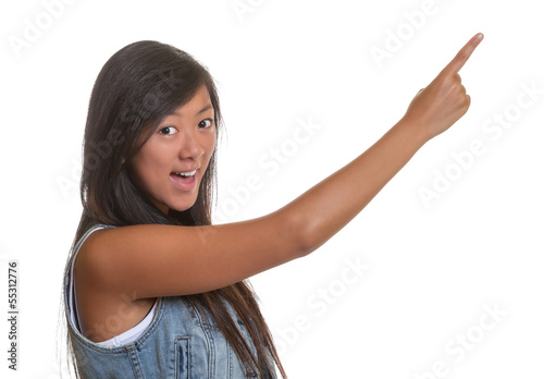 Photo: Pointing asian woman on a white background Pointing asian woman on a white background