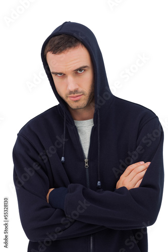 Photo: Attractive man with arms crossed looking angry Attractive man with arms crossed looking angry