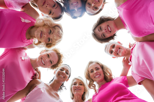 Photo: Cheerful women smiling in circle wearing pink for breast cancer Cheerful women smiling in circle wearing pink for breast cancer