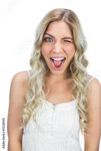 Photo: Cheerful blue eyed model winking at camera Cheerful blue eyed model winking at camera