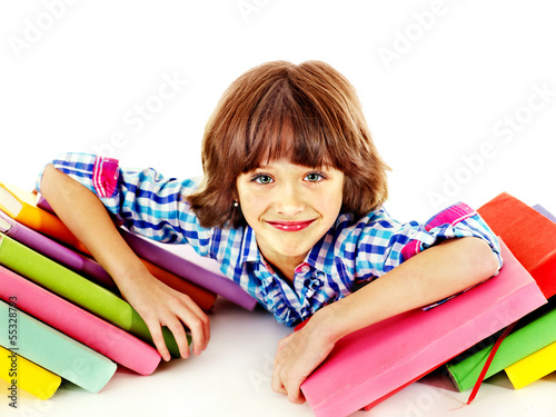 Photo: Child with stack of books. Child with stack of books.