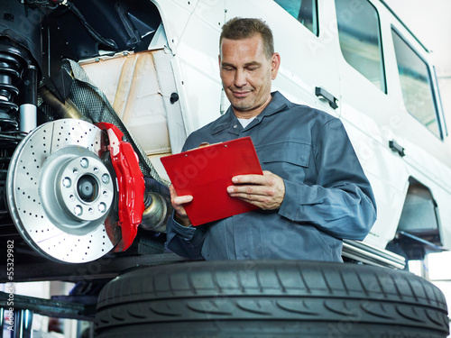 Photo: Master mechanic checking repair details Master mechanic checking repair details