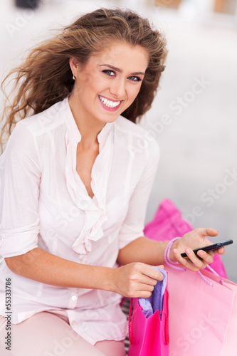 Photo: Shopping woman text messaging Shopping woman text messaging