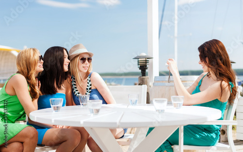 Photo: girls taking photo in cafe on the beach girls taking photo in cafe on the beach
