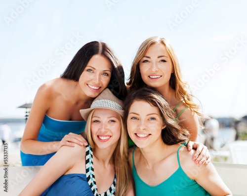 Photo: group of girls in cafe on the beach group of girls in cafe on the beach