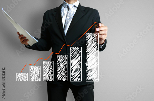 Photo: Business man hand drawing graph Business man hand drawing graph