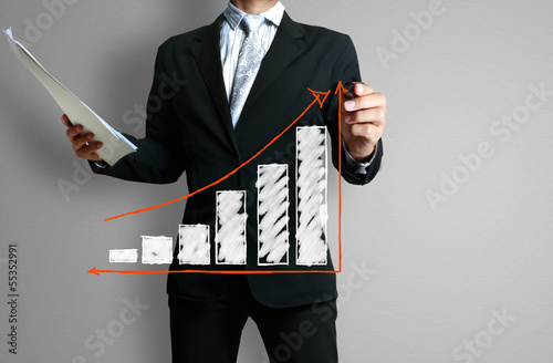 Photo: Business man hand drawing graph Business man hand drawing graph