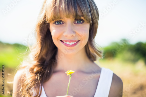 Photo: Smiling natural blonde holding dandelion Smiling natural blonde holding dandelion