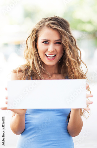 Photo: Attractive woman holding blank card Attractive woman holding blank card