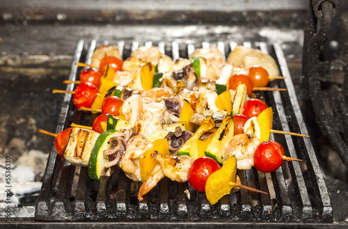Photo: skewers of seafood grilling skewers of seafood grilling