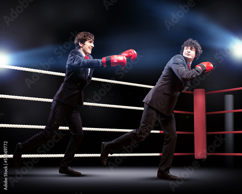 Photo: Two young businessman boxing Two young businessman boxing