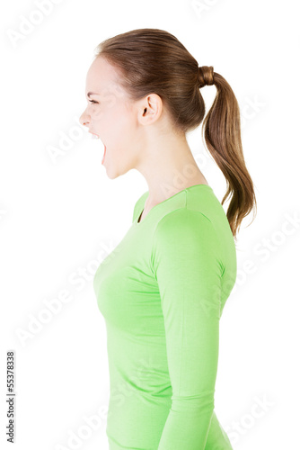 Photo: Young casual woman screaming with anger Young casual woman screaming with anger