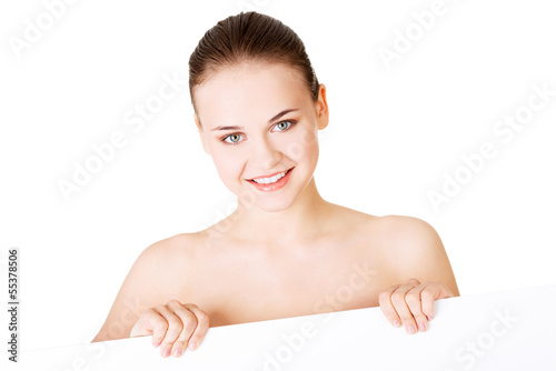 Photo: Beautiful woman with perfect skin and beautyful face holding bla Beautiful woman with perfect skin and beautyful face holding bla