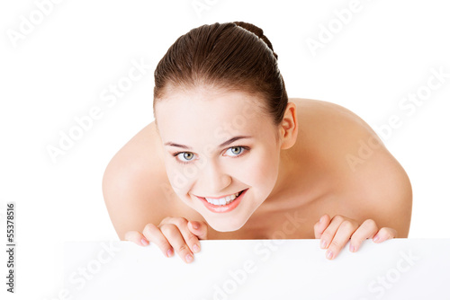 Photo: Beautiful woman with perfect skin and beautyful face holding bla Beautiful woman with perfect skin and beautyful face holding bla