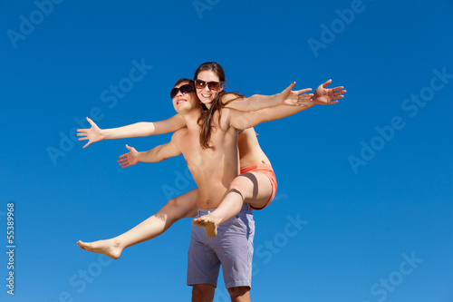 Photo: Happy Young Couple Together On The Beach Happy Young Couple Together On The Beach