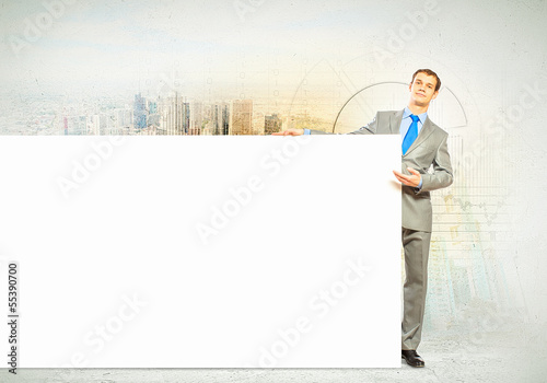 Photo: Businessman with blank banner Businessman with blank banner