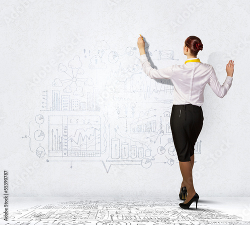 Photo: Businesswoman drawing on wall Businesswoman drawing on wall