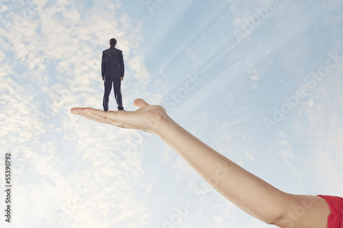 Photo: Businessman miniature in hand Businessman miniature in hand