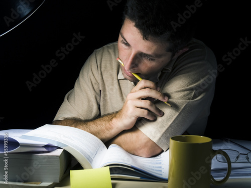 Photo: Young Man Studying at Night Young Man Studying at Night
