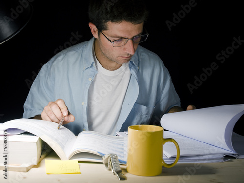 Photo: Young Man Studying at Night Young Man Studying at Night